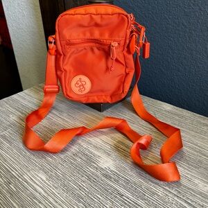 Baboon to the Moon Vibrant Orange Crossbody Bag